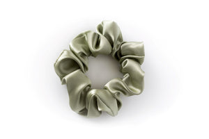 Sage green 100% mulberry silk scrunchie for anti frizz, anti breakage, hair benefits. Celebrates the wonder of natural hair by providing superior quality, professional hair products for women to achieve healthy, long, strong natural hair. Made in Toronto. 